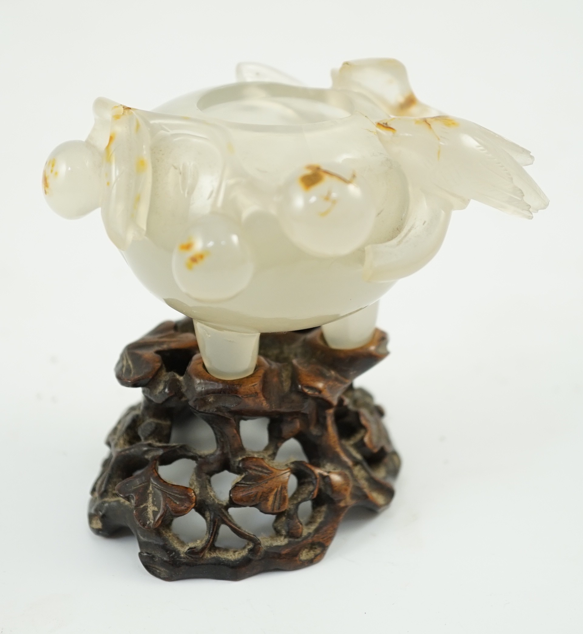 A Chinese small carved agate brushwasher on wooden stand, 19th century, 8.5cm high including stand